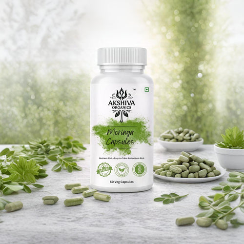 Bottle of Akshiva Organics Moringa Capsules with Moringa leaves on a natural background